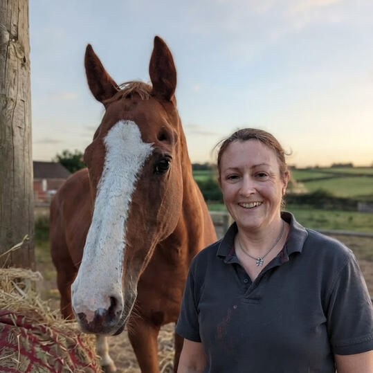 Busy lady smiling with a horse